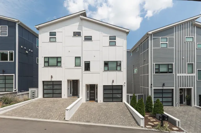 a view of a white house with many windows