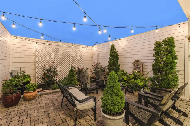 a view of a terrace with chairs and potted plants
