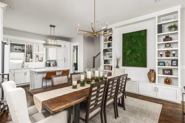 a dining room with furniture a rug and a large window
