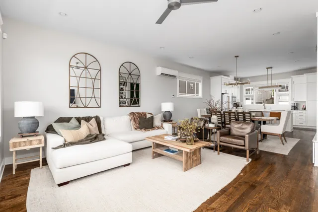 a living room with furniture white walls and wooden floor