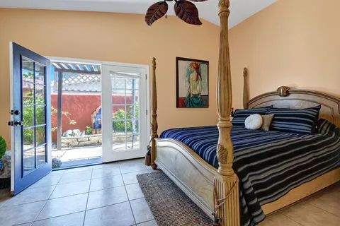 a living room with a bed furniture and a large window