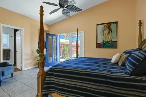 a bedroom with a bed and a chandelier