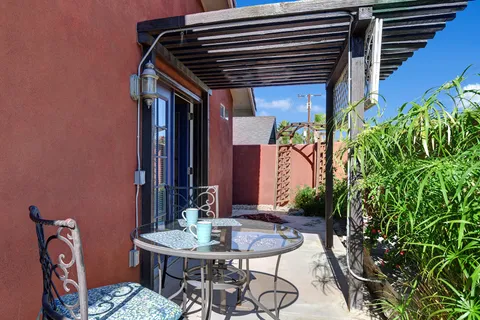 a backyard of a house with table and chairs