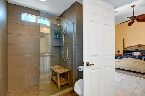 a bathroom with a toilet and a shower