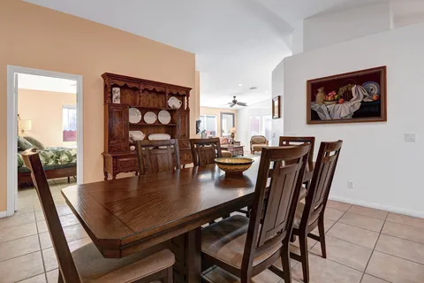 a dining room with furniture and wooden floor