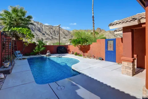 a view of a patio with table and chairs potted plants