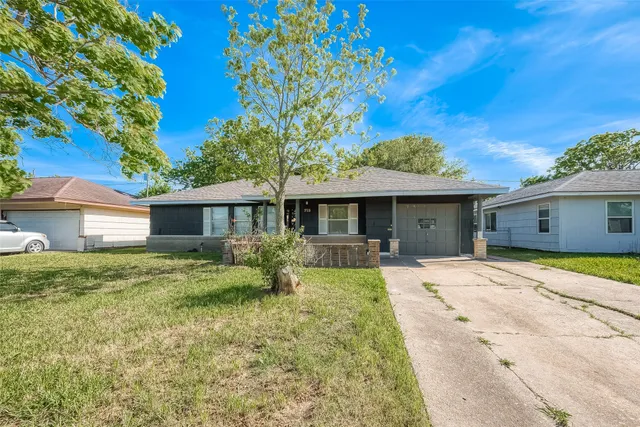 a front view of a house with a garden and porch
