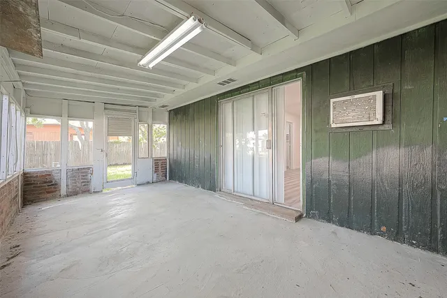 a view of an empty room with windows