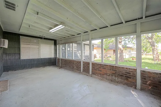 a view of an empty room with windows