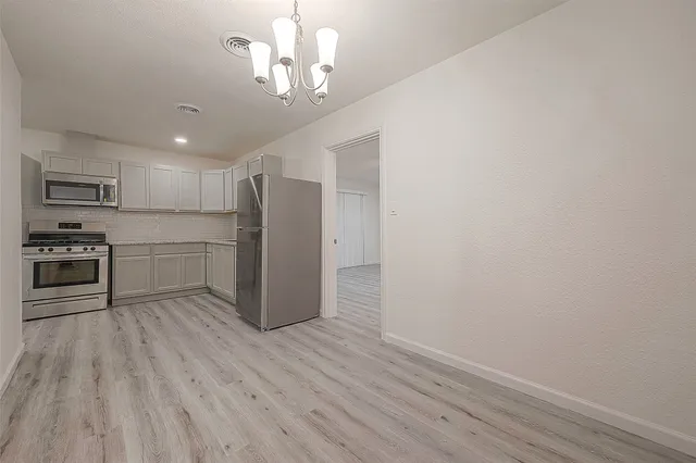 a view of a kitchen with a sink and a refrigerator