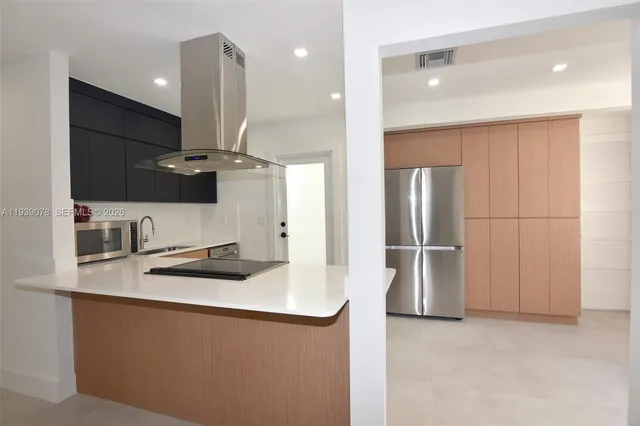 a kitchen with stainless steel appliances a refrigerator and a sink