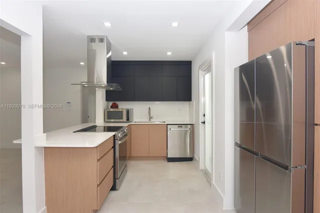 a kitchen with a refrigerator sink and stove