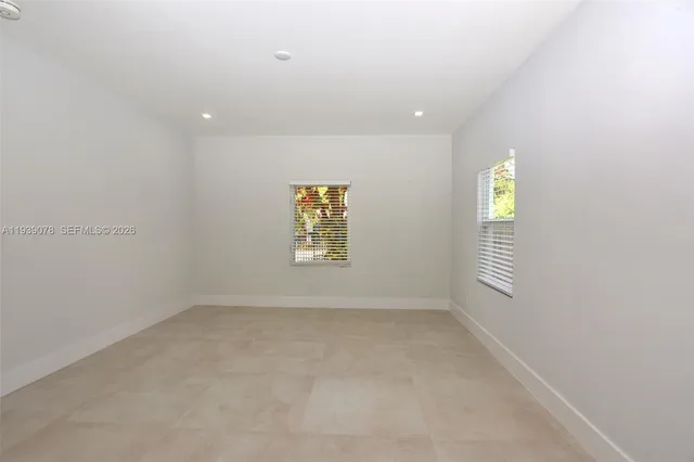 a bathroom with a bathtub shower sink vanity and a toilet