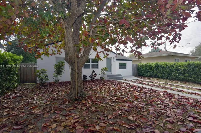 a house with a tree in front of it