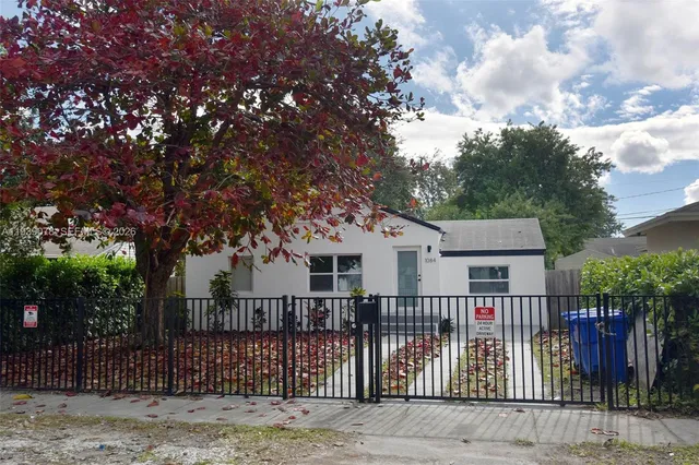 a front view of house with yard and trees