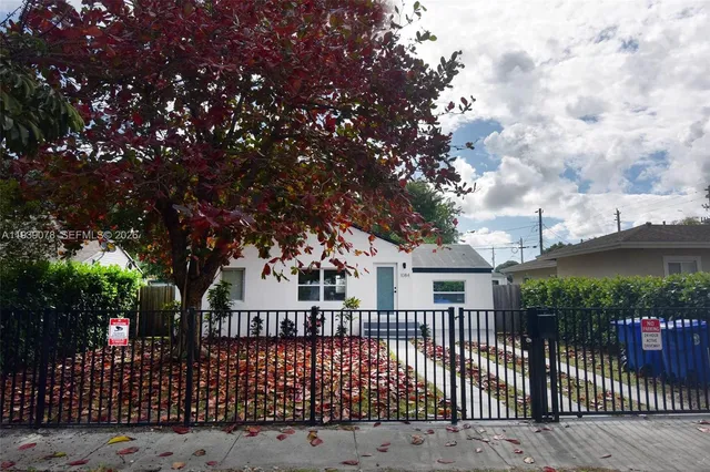 a view of house with a tree in front