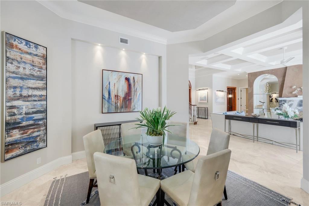 14459 Marsala Way Naples, FL 34109 - Photo 16 of 50 a view of a dining room with furniture and a potted plant