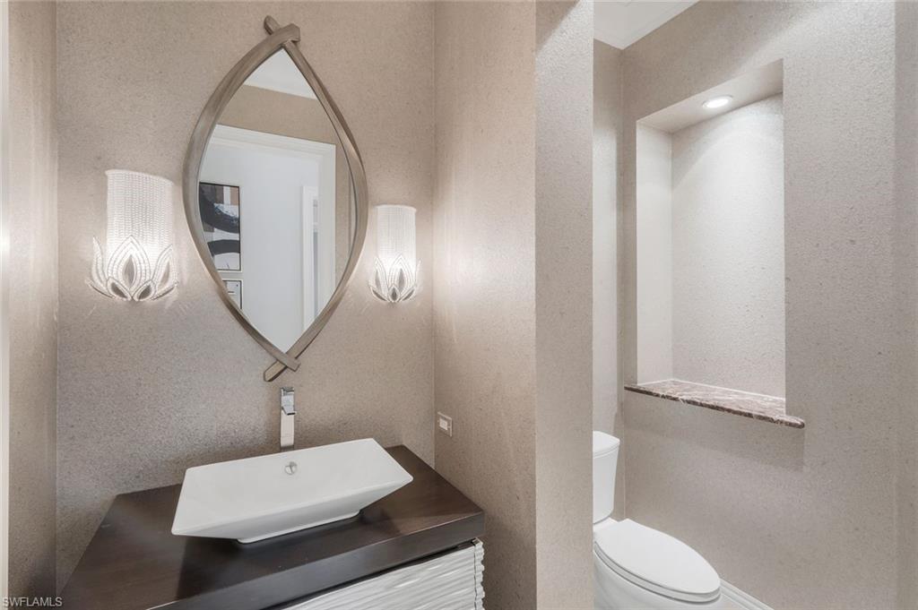 14459 Marsala Way Naples, FL 34109 - Photo 17 of 50 a bathroom with a sink a toilet and a mirror