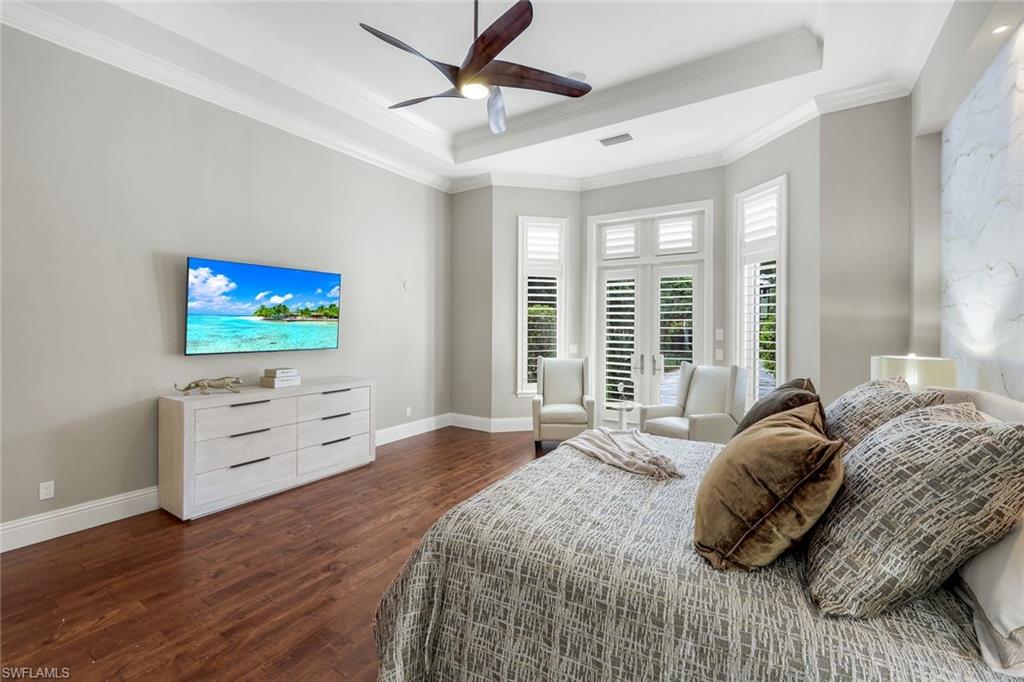 14459 Marsala Way Naples, FL 34109 - Photo 21 of 50 a bedroom with a bed and a flat screen tv
