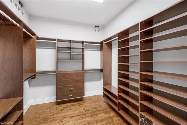 a view of walk in closet and bedroom