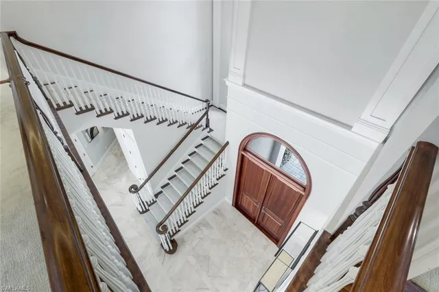 a view of staircase with white walls and a window