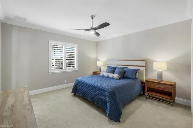 a bedroom with a bed next to a window