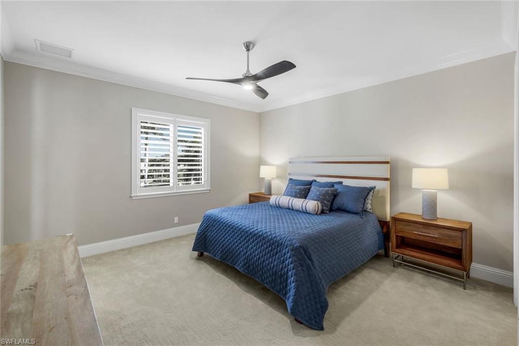 14459 Marsala Way Naples, FL 34109 - Photo 28 of 50 a bedroom with a bed next to a window