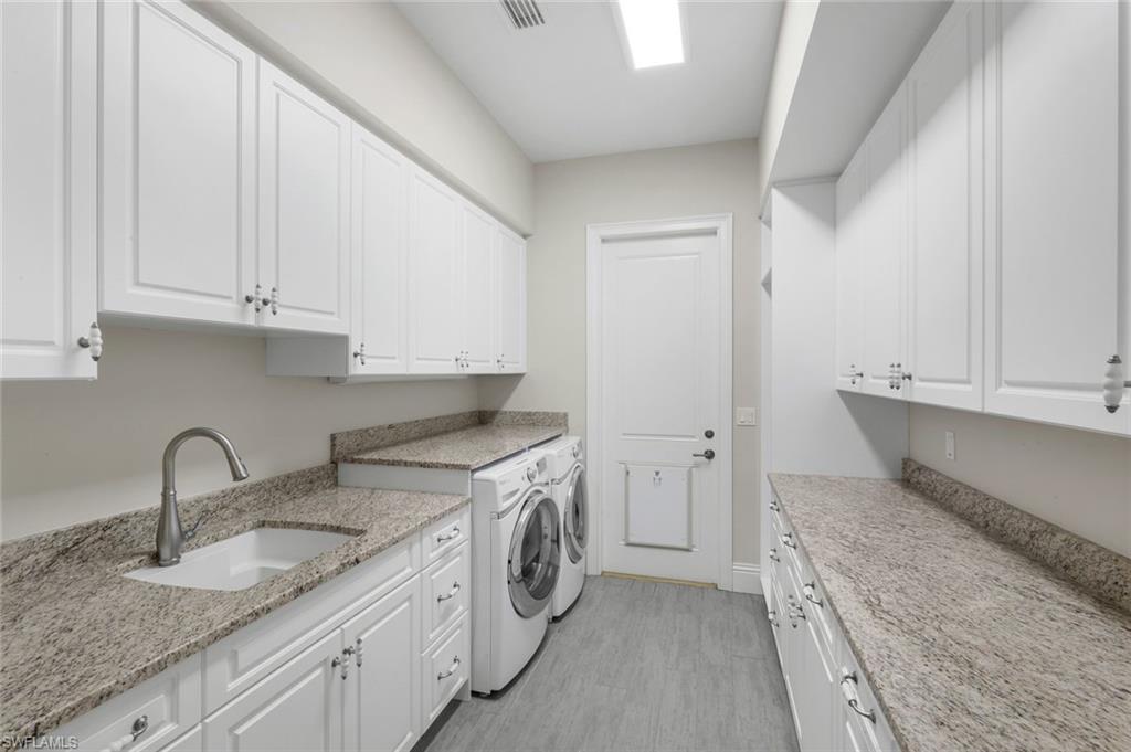 14459 Marsala Way Naples, FL 34109 - Photo 33 of 50 a kitchen that has a sink and a stove