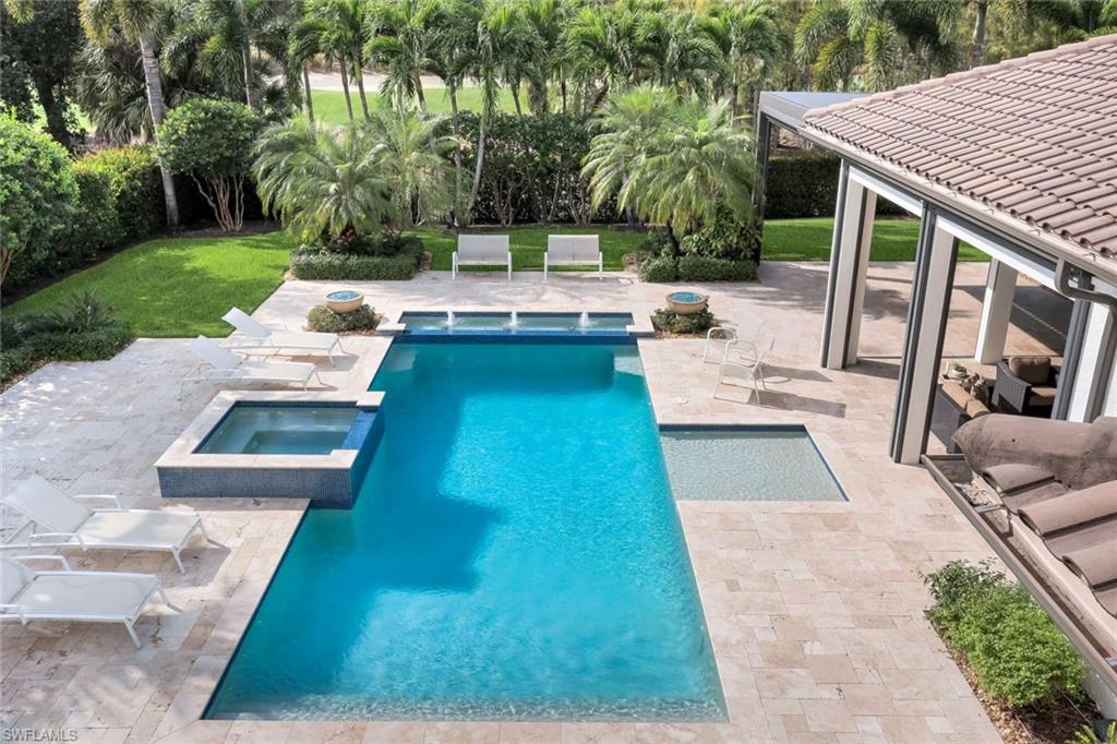 14459 Marsala Way Naples, FL 34109 - Photo 35 of 50 a view of a patio with couches table and chairs with plants and trees
