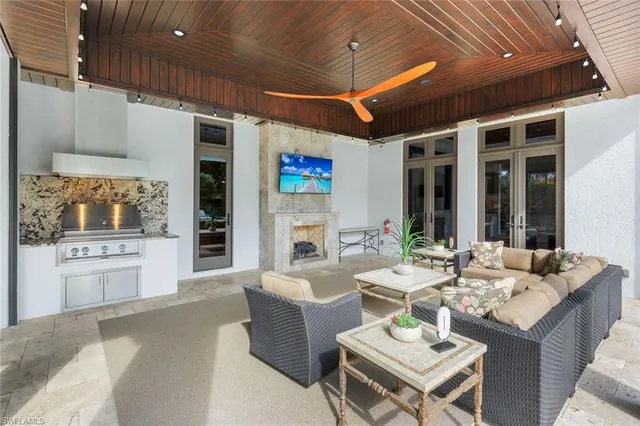 a living room with fireplace furniture and a kitchen