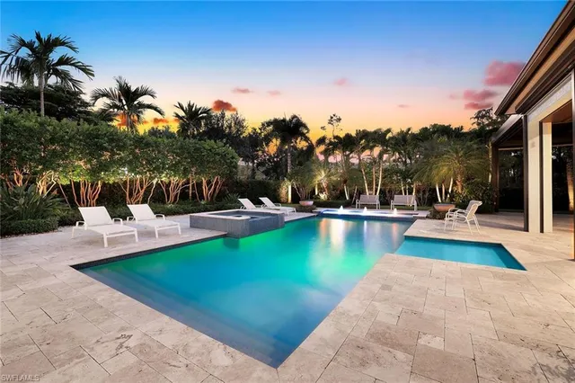 a view of a swimming pool with lounge chairs
