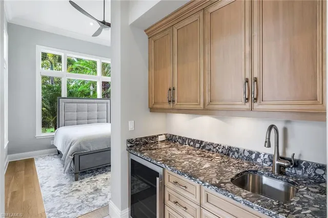 a kitchen with granite countertop a sink stove and cabinets