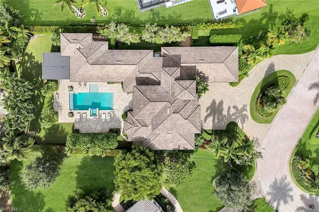 an aerial view of a house with outdoor space and a lake view