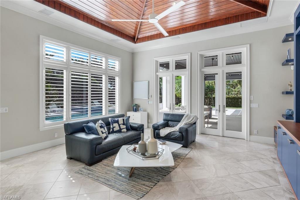 14459 Marsala Way Naples, FL 34109 - Photo 7 of 50 a living room with furniture and floor to ceiling windows