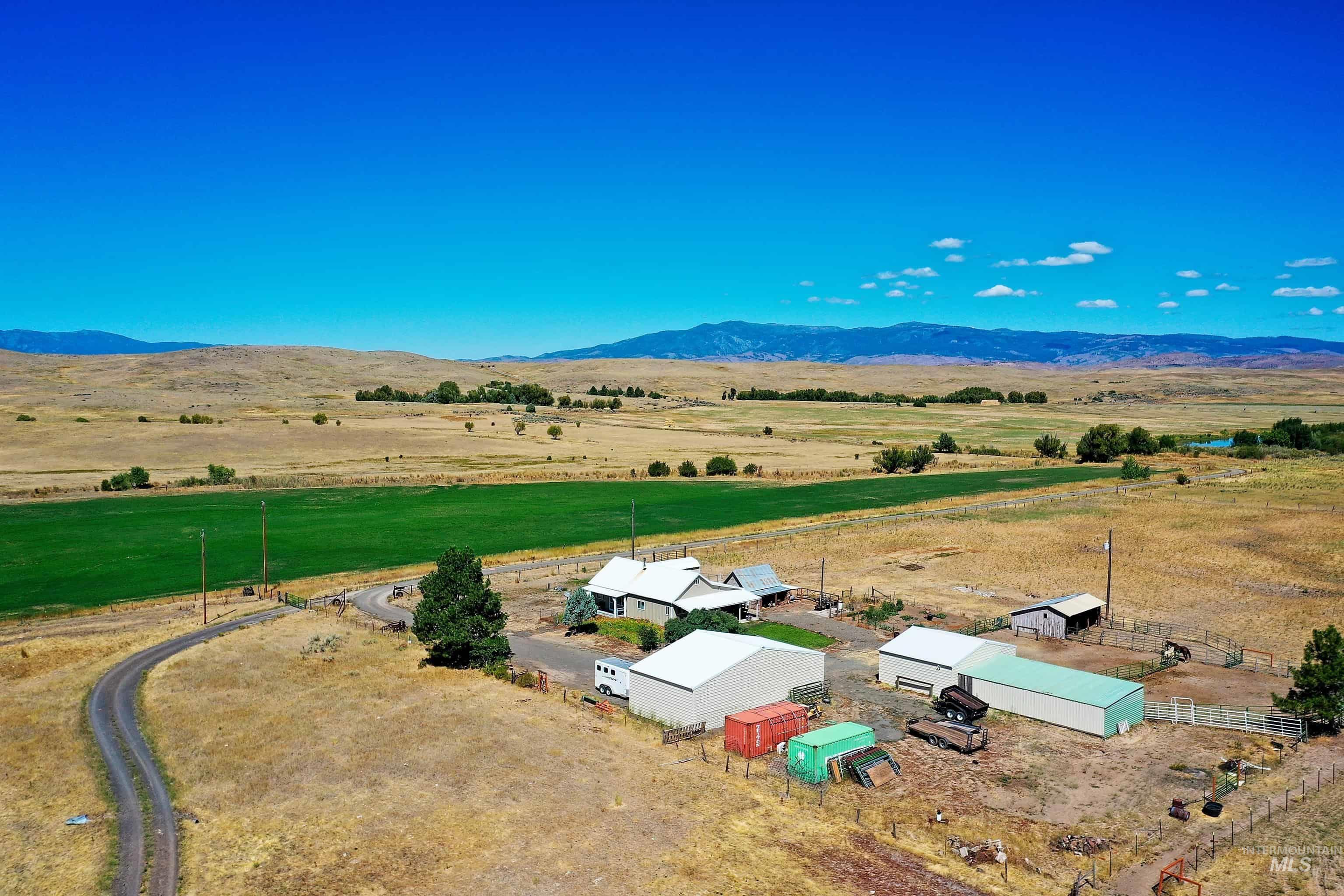 724 Mundy Gulch Road Indian Valley, ID 83632 - Photo 2 of 43 Aerial view of sparsely populated area featuring a mountainous background