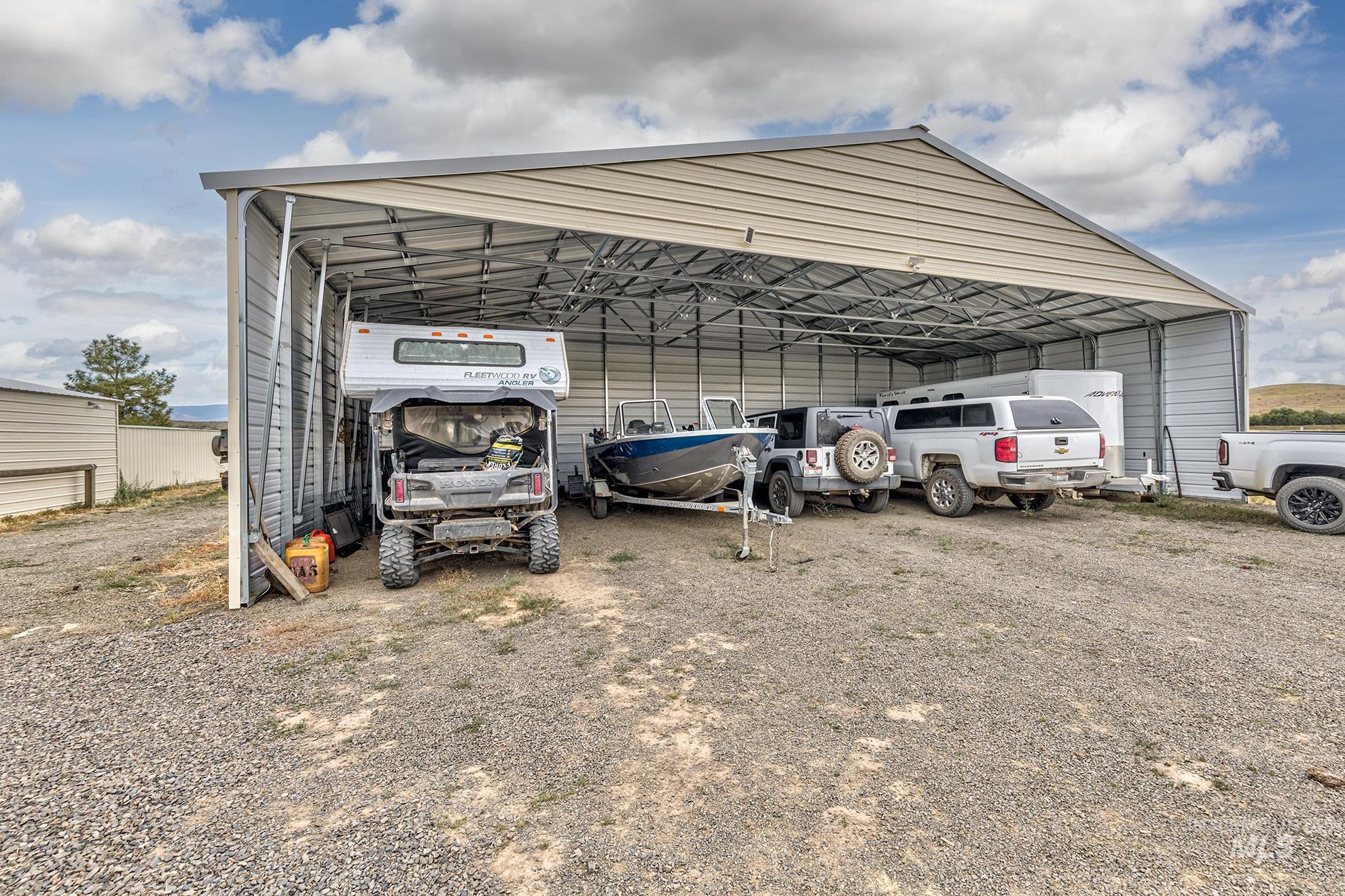 724 Mundy Gulch Road Indian Valley, ID 83632 - Photo 30 of 43 View of vehicle parking featuring a carport and dirt driveway