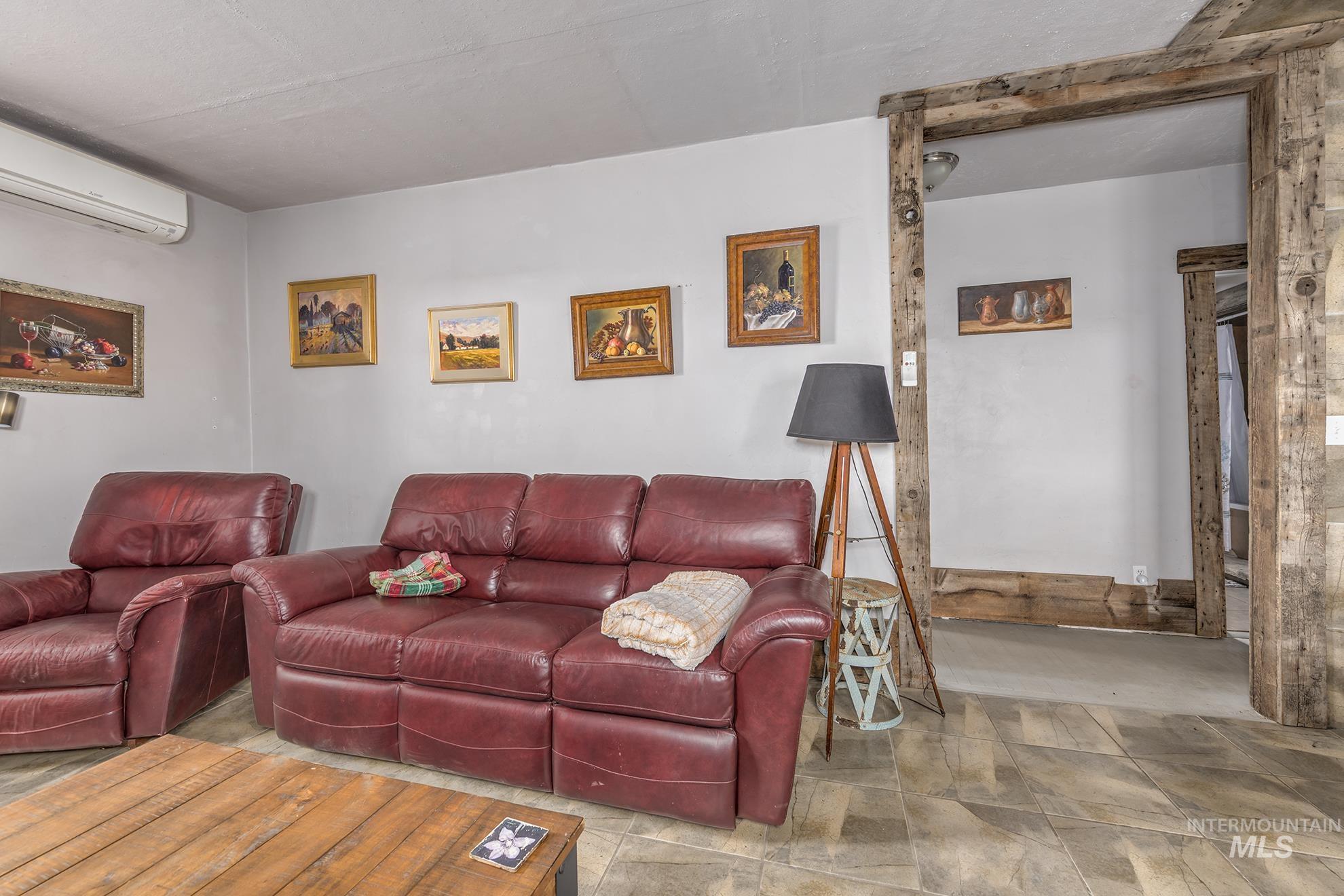 724 Mundy Gulch Road Indian Valley, ID 83632 - Photo 7 of 43 Living room featuring a wall unit AC