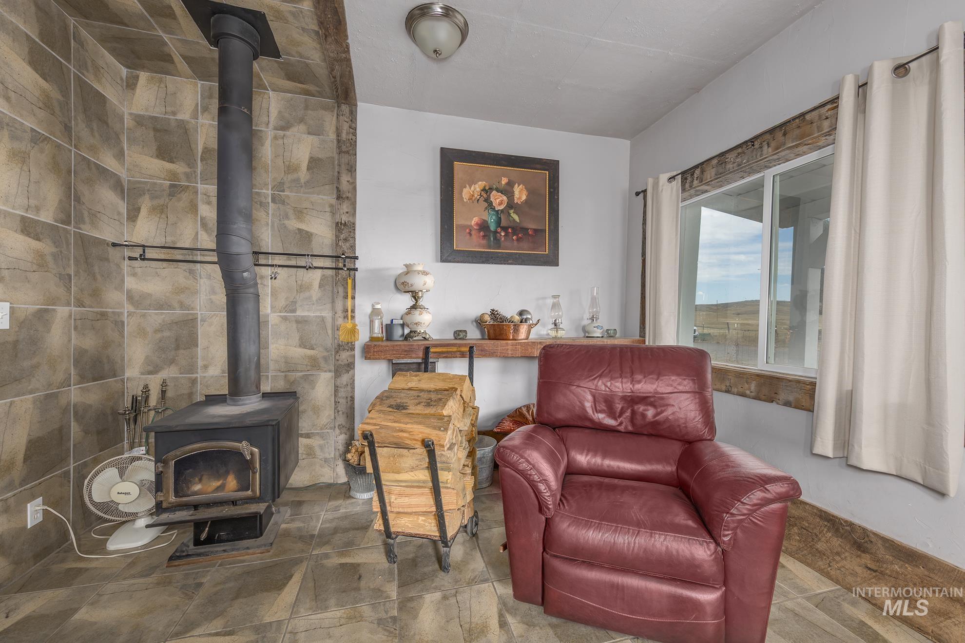 724 Mundy Gulch Road Indian Valley, ID 83632 - Photo 8 of 43 Living area featuring a wood stove
