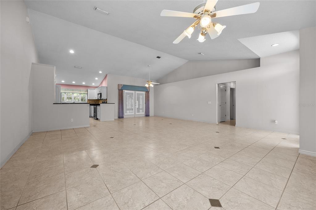 3951 Myrtle Street St. Augustine, FL 32084 - Photo 5 of 23 a view of a livingroom with a chandelier fan and kitchen view