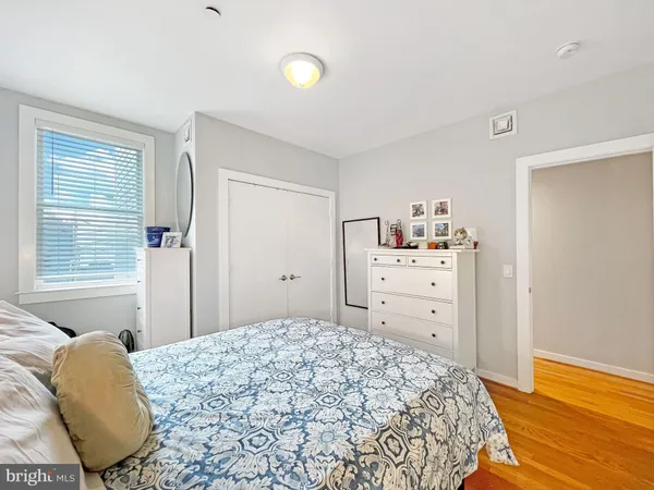 a bedroom with a bed and a dresser