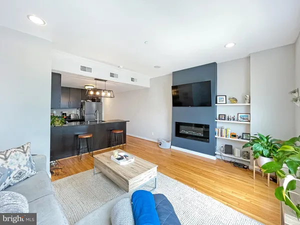 a living room with fireplace furniture and a flat screen tv