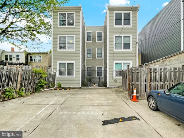 a view of a house with a cars park side of a road