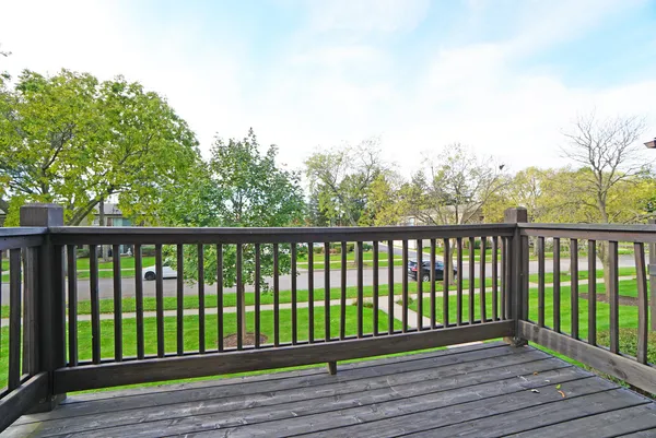 a view of balcony with wooden floor