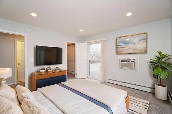 a bedroom with furniture and a flat screen tv