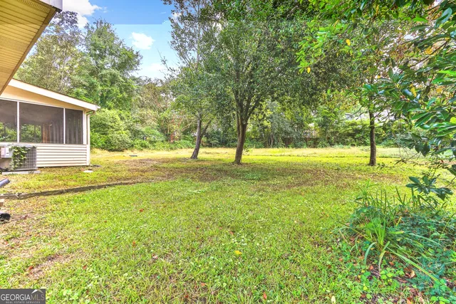 a view of yard with swimming pool and tree s