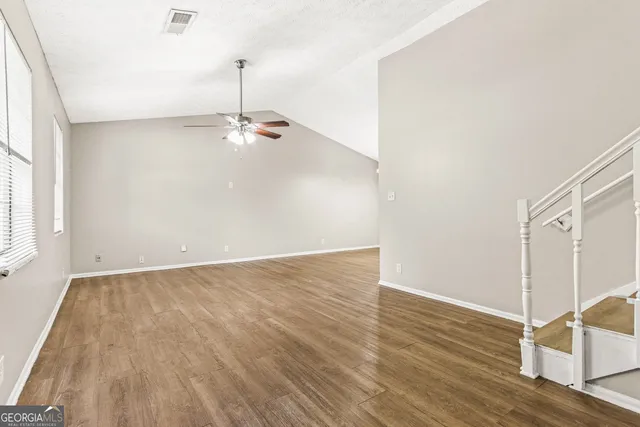 a view of a room with wooden floor and window