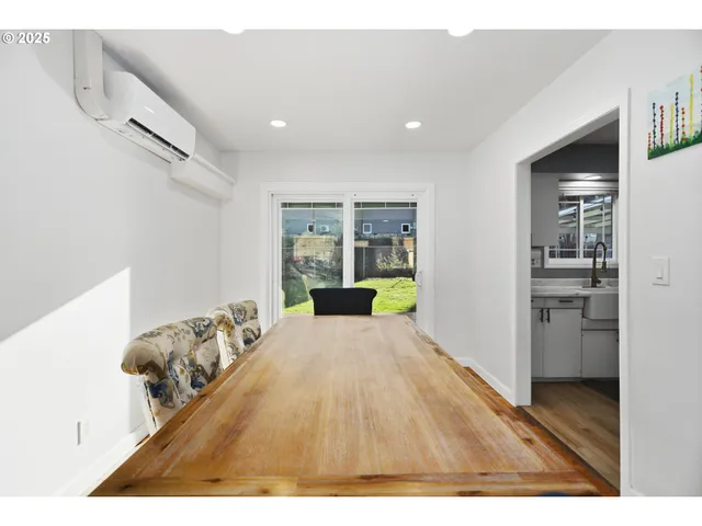 a open hall with wooden floor and furniture