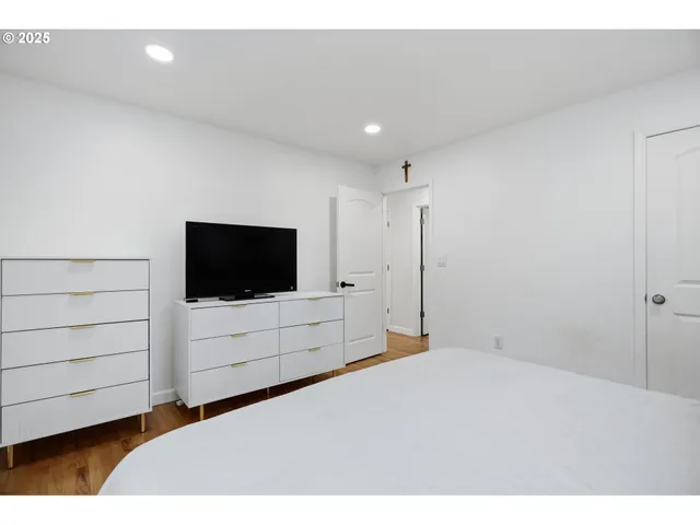 a bedroom with a bed and a flat screen tv