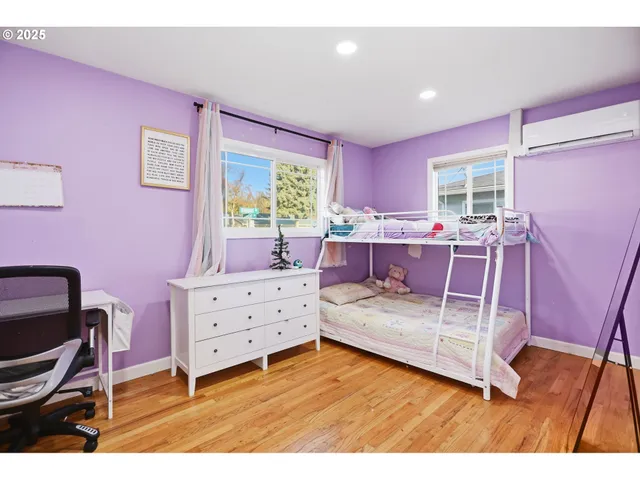 a bedroom with a bed and a desk