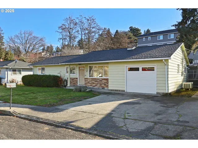 a view of backyard of house and car parked
